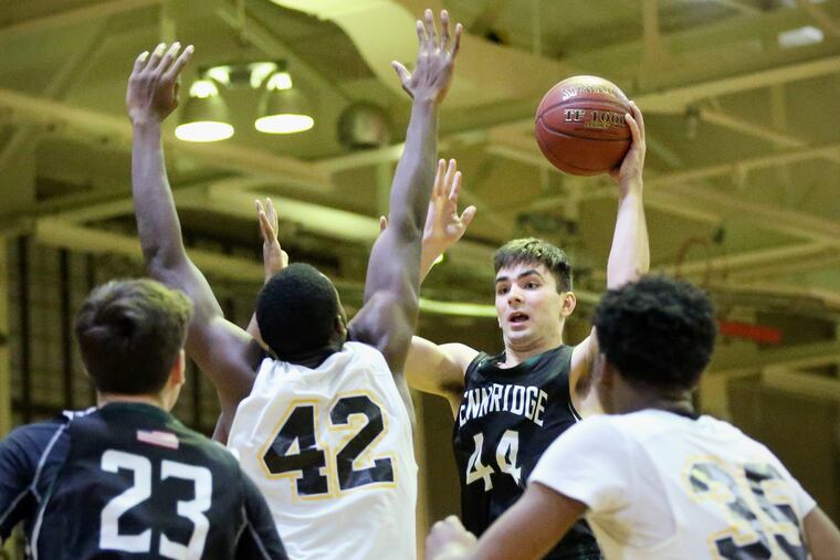 Pennridge's Jonathan Post looks to make a pass around Lincoln's Oluwadara Idowu on Saturday. Pennridge topped Lincoln, 49-45, and will go on to play Abington in the Class 2A playoffs.