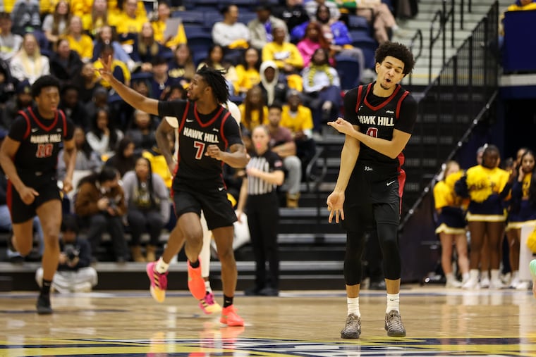 St. Joe's guard Derek Simpson (right) reacts after a three-point basket during the first half against La Salle on Saturday.