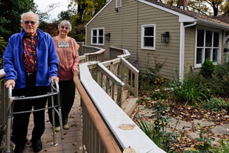 Don and Helen Johnson stand on a ramp attached to the back deck of their Belmont Hills home designed for Don, who uses a walker or wheelchair. The house has wide doorways and an elevator. (Ron Tarver / Staff Photographer)