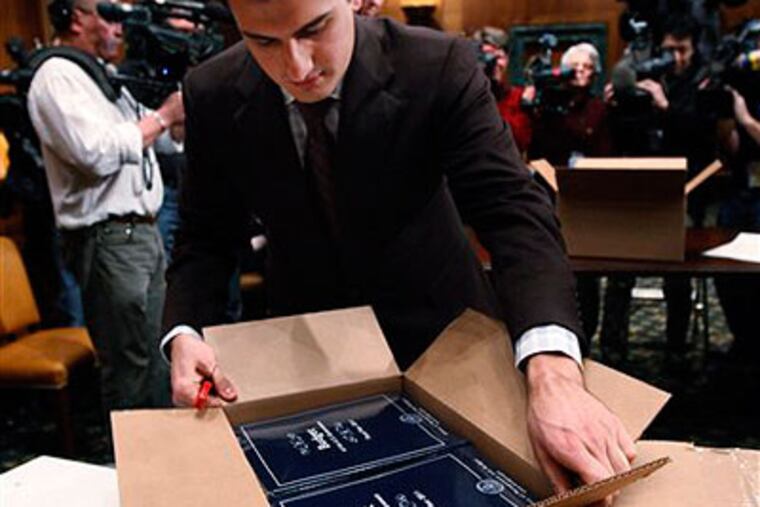 A Senate staffer unpacks copies of the Obama administration's proposed budget. (AP Photo / Manuel Balce Ceneta)