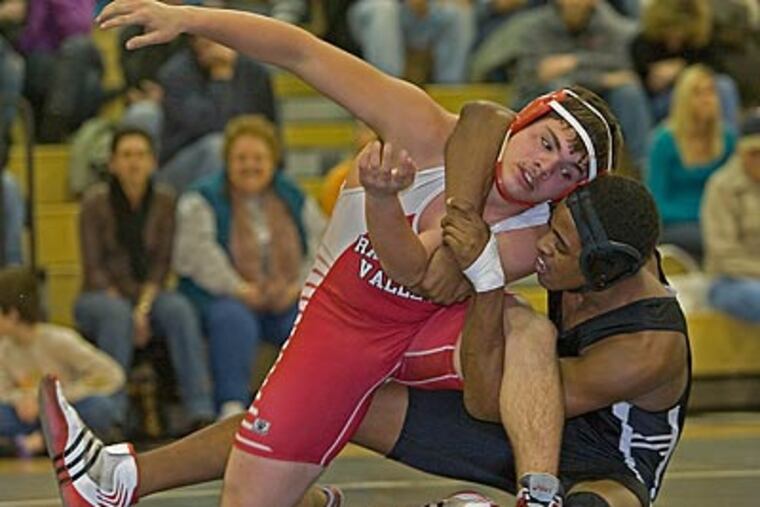 Burlington Township’s Jared Holliday pins Chad Bauman of Rancocas Valley in their 189-pound match in the first period. The Falcons are undefeated this season. (David M Warren / Staff Photographer)