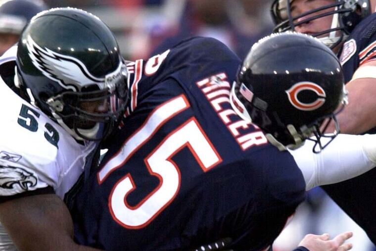 Bears QB Jim Miller is taken down by Hugh Douglas in Eagles NFC playoff victory in 2002. (AP file photo/Charles Rex Arbogast)