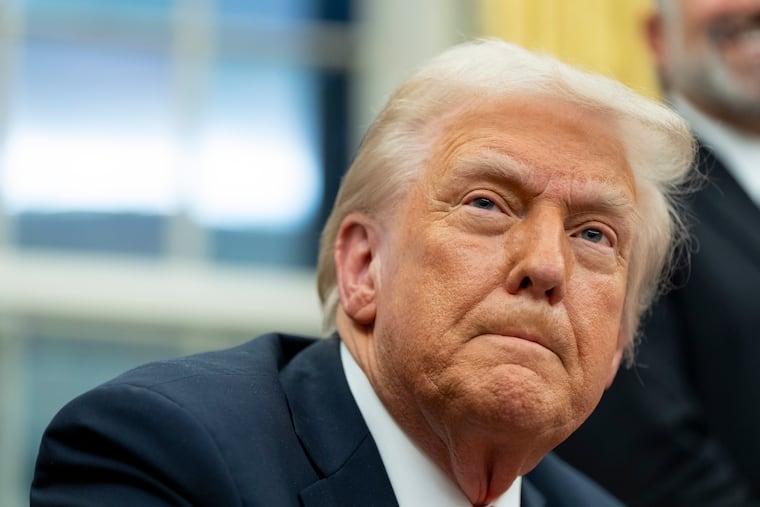 President Donald Trump speaks with reporters Tuesday as he signs executive orders in the Oval Office.