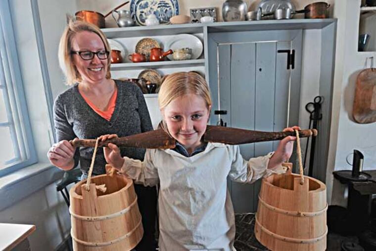 Jennifer Janofsky, curator of the Whitall House in National Park, photographed at the House with her children Grace Janofsky, 9; and Luke Janofsky, 7, on Feb. 6, 2014. Here, Grace holds a yoke. ( APRIL SAUL / Staff )