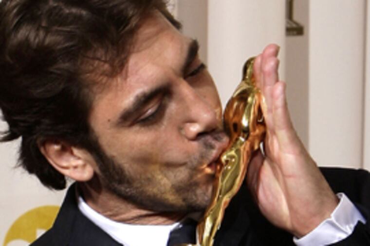 Spanish actor Javier Bardem kisses his Oscar for best supporting actor for his work in "No Country for Old Men."