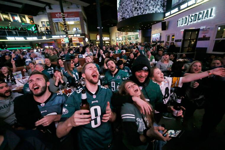 Eric Trisch of Pottstown (center, front) cheers as the Eagles increase their lead over the Redskins 17-0 on Sunday at Xfinity Live! in South Philadelphia. The Eagles defeated the Washington Redskins to clinch a playoff spot.