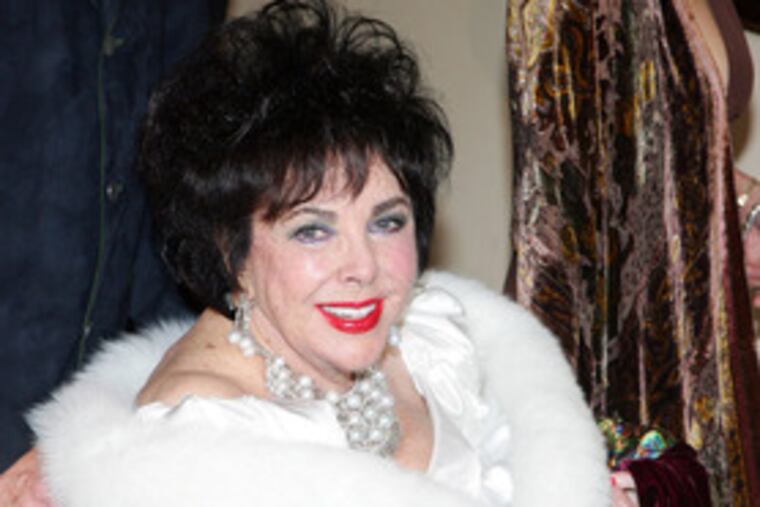 Magicians Siegfried (left) and Roy , above, were among guests at Elizabeth Taylor's 75th birthday bash. Taylor, in diamonds and fur, arrived in a wheelchair.