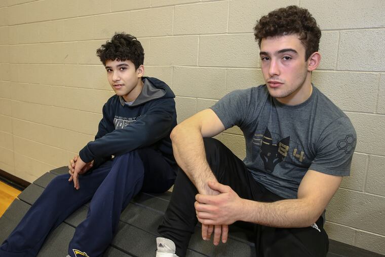 Wrestling brothers Matt (left) and Ryan Vulakh take a break at practice.