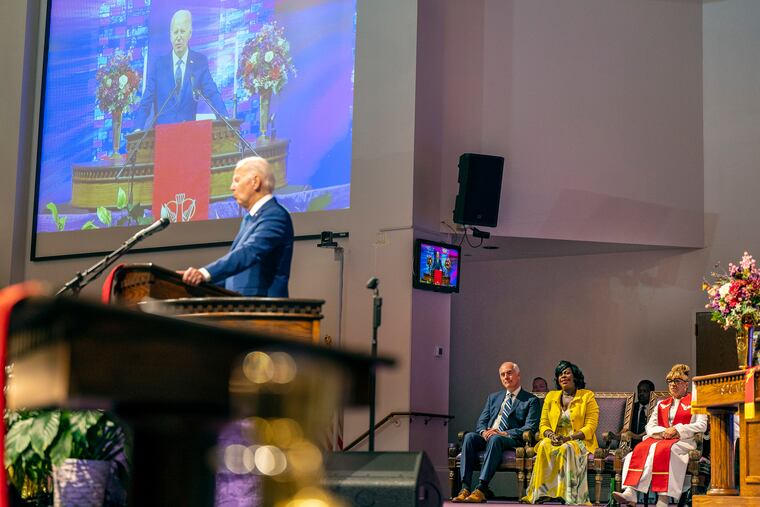 President Joe Biden speaks from the pulpit at Mt Airy Church of God in Christ Sunday, July 7, 2024. U.S. Senator Bob Casey and Mayor Cherelle L. Parker are seated at right.