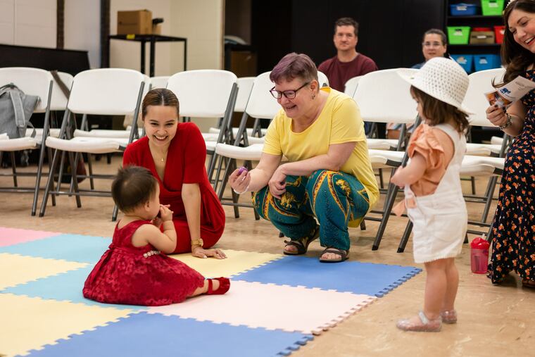 Lynn Gumert, professor of music therapy, plays with the children of guests of the Lullaby Project performance at Rowan University in Glassboro on Friday, June 30, 2023. The Lullaby Project is a project of Carnegie Hall, partnering with other music and social programs in the U.S. and other countries in which caregivers create lullabies for their babies, but in the process think about being caregivers and what they want for their children.