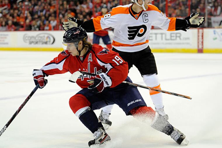 Claude Giroux (28) loses his stick against Washington Capitals center Nicklas Backstrom (19), of Sweden, during the first period of an NHL hockey game, Friday, Feb. 1, 2013, in Washington. (Nick Wass/AP)