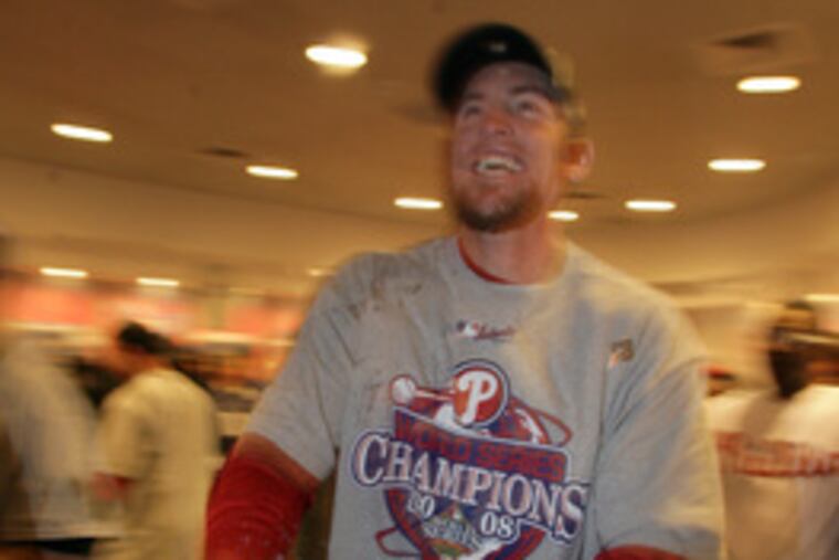 Brad Lidge celebrates with champagne after saving the series-clincher.