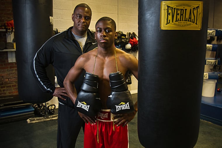 Dylan Price, 16, a student at Commonwealth Connections Academy will compete in National Golden Gloves on April 25, 2015. Photograph of him at Joe Hand Gym 545 N. 3rd St. Philadelphia on Wednesday, April 15, 2015. Behind Dylan is father Dave Price. (Alejandro A. Alvarez/Staff Photographer)