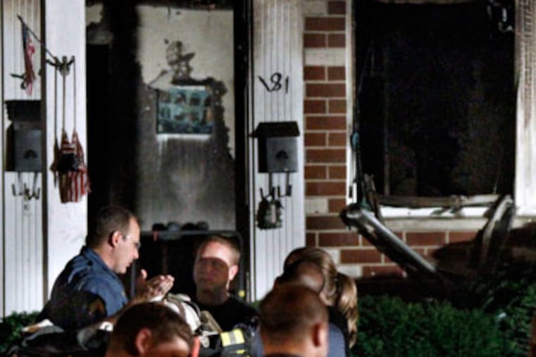Officials investigating a fire that killed a man just before midnight in an apartment at Bellmawr Manor Apts, in Bellmawr, N.J. A woman was also injured. ( Elizabeth Robertson / Staff Photographer )