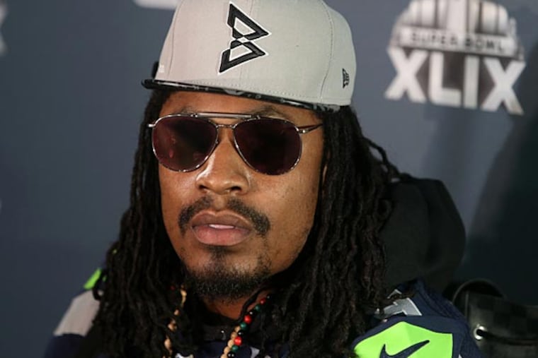 Seattle Seahawks running back Marshawn Lynch with reporters during the Seattle Seahawks press conference at Arizona Grand. (Peter Casey/USA Today)