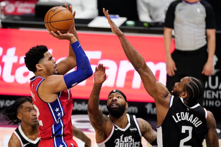 Tobias Harris shoots as Los Angeles Clippers forward Marcus Morris and forward Kawhi Leonard defend him.
