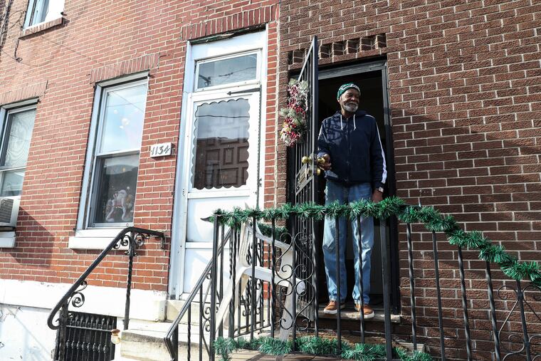 Eddie Burton laughs after Craig Robbins, Philadelphia Regional Director of the For Our Future Action Fund, spoke with him in the Point Breeze neighborhood in Philadelphia, Pennsylvania on Wednesday, December 11, 2019. The For Our Future Action Fund promotes progressive values and causes. While out door knocking, Robbins asked registered voters what issues they cared about most.