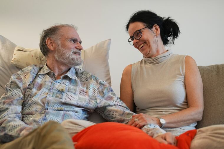 Michael Bommer, left, who is terminally ill with colon cancer, looks at his wife Anett Bommer at their home in Berlin, Germany.