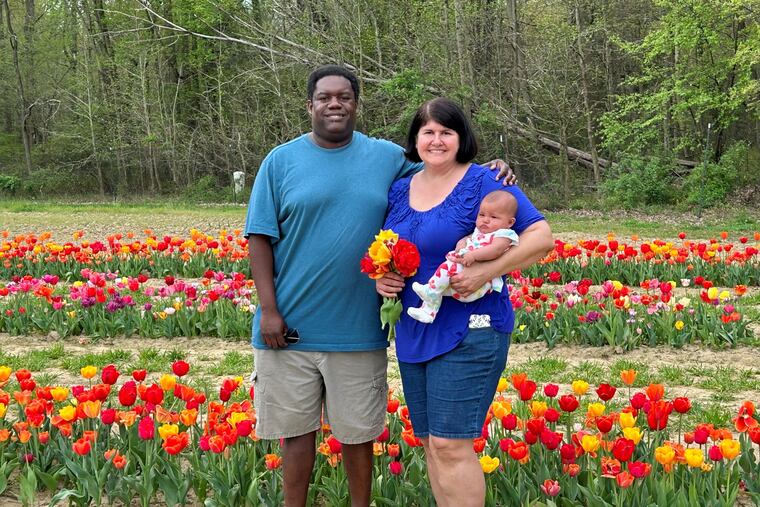 Aileen, Tim, and baby Violet picking tulips at Dalton Farm.