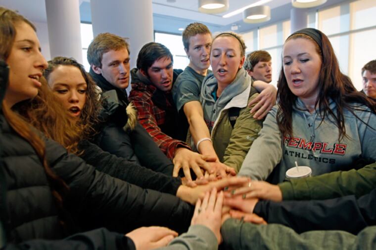 Female and male members of Temple's crew teams create a moment of solidarity Tuesday night after the Temple Board of Trustees meeting where they were not allowed to speak. (MICHAEL BRYANT/Staff Photographer)