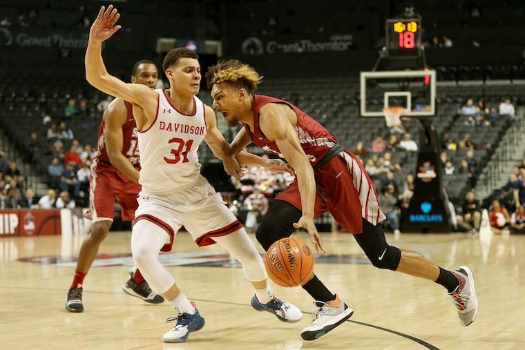 Charlie Brown (right), here driving against Davidson's Kellan Grady, might get selected in the second round of the NBA draft Thursday.