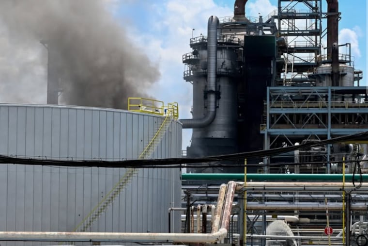 Firefighters at Delta Air Lines' Monroe Energy refinery in Trainer, Delaware County, on Thursday.