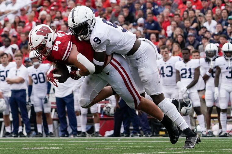 Wisconsin's Jake Ferguson catches a pass in front of Penn State's Joey Porter Jr. during the first half in Madison, Wis.