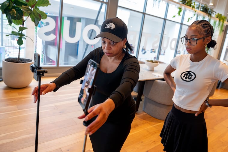 “Anything that seems inauthentic or that they can’t relate to, they’re turning away. People want to be inspired, but not basically lied to,” says Gloria Ross, one of the unaesthetic moms on Instagram. Above, she sets up smartphones to record a video with daughter Sahara recently.