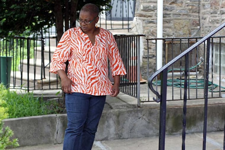 Vicki Mines stands in front of her neighbor's home, which was fumigated by the city today. She says she cried "tears of joy" when she found out the infestation of mice and roaches was being addressed. (Yong Kim/Staff)