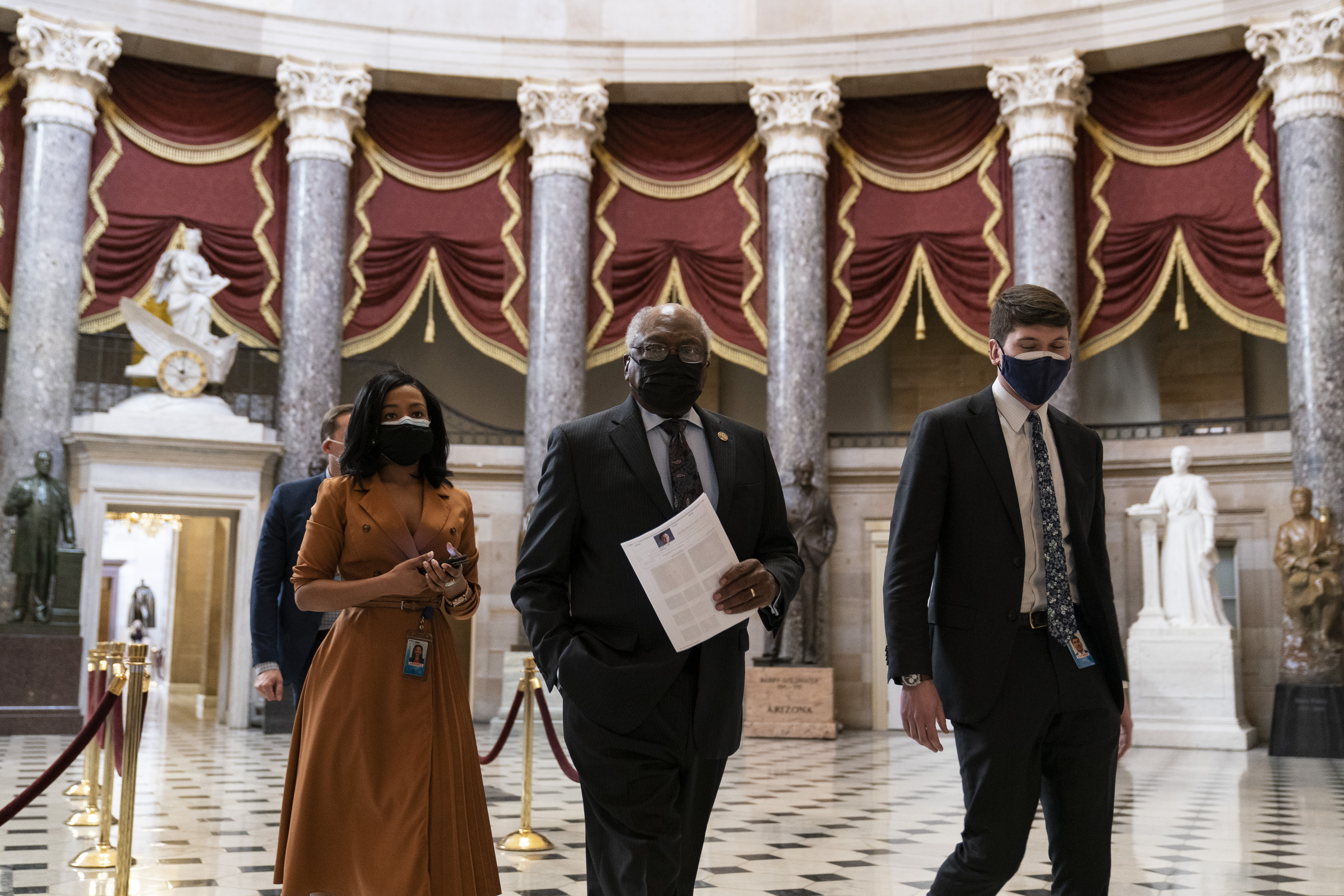 House Majority Whip James Clyburn of S.C., center, walks through Statuary Hall before the vote on the Democrats' $1.9 trillion COVID-19 relief bill on Capitol Hill on Wednesday.