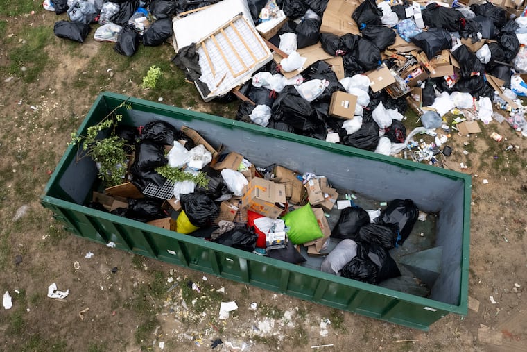 A large pile of trash near the city drop-off site at 8th and Master Streets on Monday.