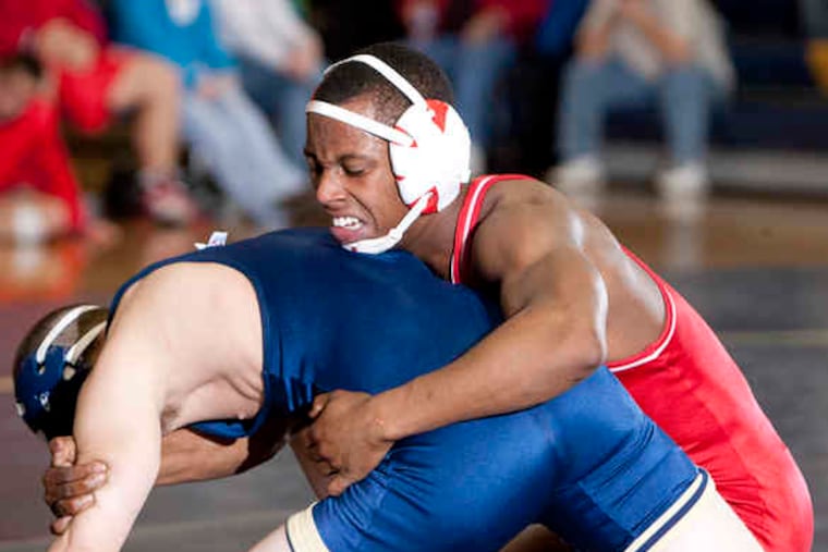 Paulsboro's Tyree Ellis (right) put away Collingswood's Alex Irwin with a 9-4 decision in the 135-pound bout. Paulsboro won nine of 14 bouts, with five pins and a forfeit win at 119.