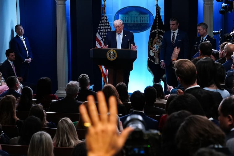 President Donald Trump, accompanied by Defense Secretary Pete Hegseth and Gen. Dan Caine, chairman of the Joint Chiefs of Staff, speaks with reporters Monday at the White House.
