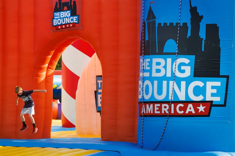 A kid jumps at the entrance to one of the big bounce play areas. The Big Bounce America runs weekends through Sept. 10th at the Navy Yard.