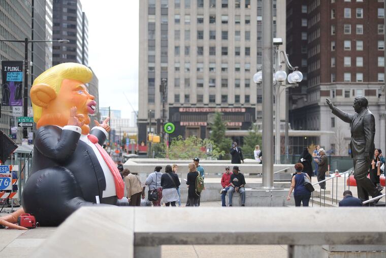 The Trump Rat, by Philadelphia-born artist John Post Lee, waves back to the Center City Frank Rizzo sculpture on Rizzo's birthday, Oct. 23, 2017.