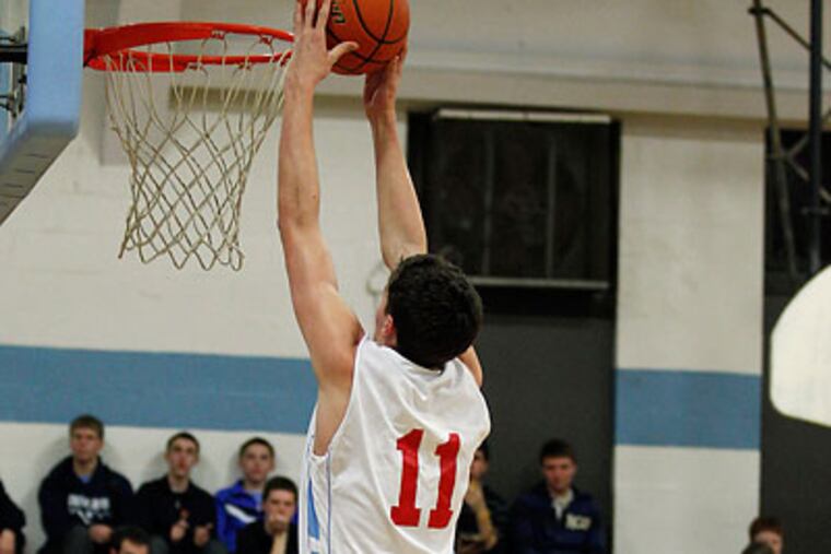 Father Judge's Brian Hennessey slam dunks the ball
over Bishop McDevitt's Kenyatta Long. (Yong Kim/Staff Photographer)