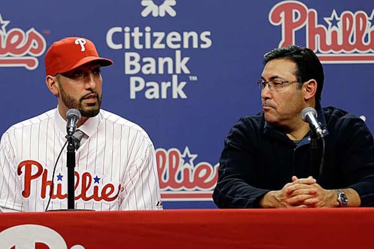 Phillies new relief pitcher Mike Adams (left) speaks as GM Ruben Amaro Jr., listens during a newsconference, Thursday, Dec. 20, 2012, in Philadelphia. (Matt Rourke/AP)