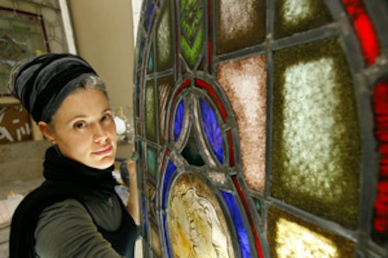 Before Emily Selvin restored this window, the center panel, far right, was missing. Besides restoration work for churches, she creates stained-glass artworks for private customers.