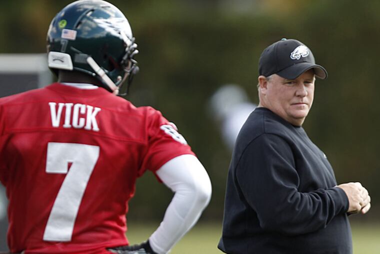 Eagles quarterback Michael Vick and head coach Chip Kelly. (David Maialetti/Staff Photographer)