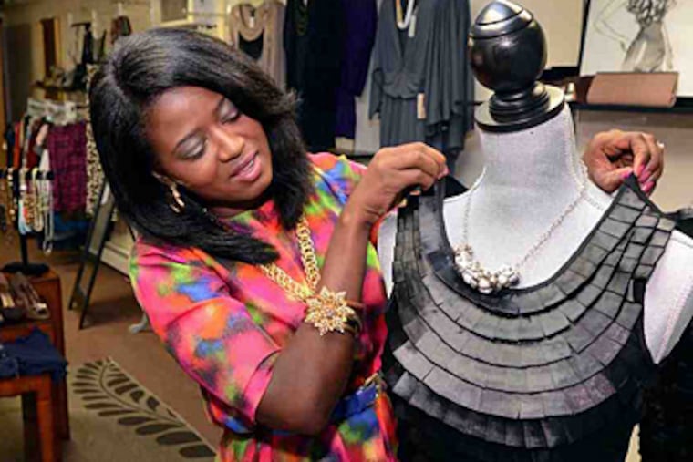 Sheila Fortson-Williams puts together an outfit in her boutique that she bought at a thrift store.(MARK C. PSORAS / Daily News)