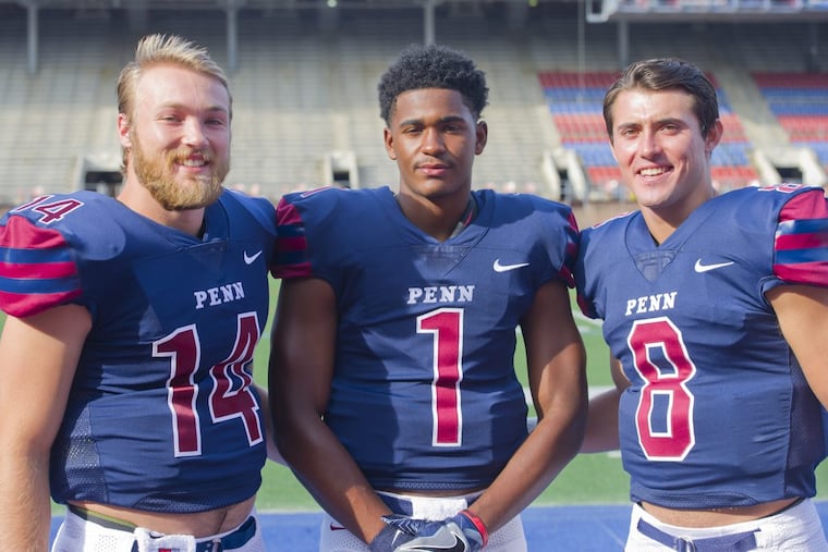 Quarterbacks (from left) Will Fischer-Colbrie, Ryan Glover, and Nick Robinson pose for photos during Penn Football Media Day at Franklin Field.