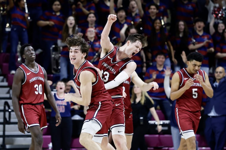 Penn guard AJ Levine (left) and forward Ethan Roberts celebrate Penn’s 64-61 victory over Harvard on Saturday, Feb. 28, 2026 in Philadelphia.