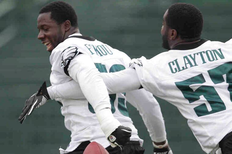Eagles linebacker Keenan Clayton strips the ball from Moise Fokou during a drill at training camp. Team workouts will be opened to fans on Saturday at Lehigh University.