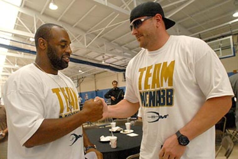 Donovan McNabb greets Todd Herremans at his annual football camp in Marlton. (April Saul / Staff Photographer)