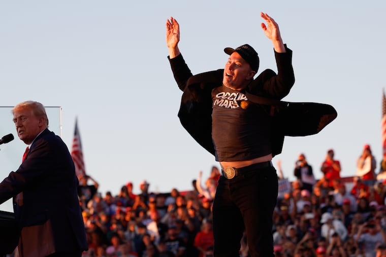 Elon Musk jumps on the stage as Republican presidential nominee former President Donald Trump speaks at a campaign rally at the Butler Farm Show in Butler, Pa.