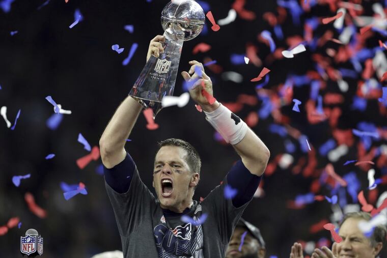 Tom Brady holds up the Lombardi Trophy after his New England Patriots rallied to beat Atlanta in last year’s Super Bowl.(AP Photo/Darron Cummings, File)