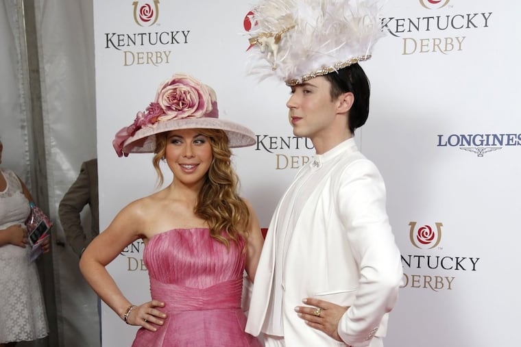 Former figure skating stars Tara Lipinski and Johnny Weir appear on the red carpet before the 140th running of the Kentucky Derby at Churchill Downs in Louisville, Ky., on May 3, 2014.
