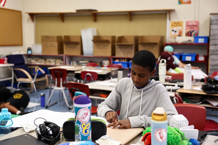 Fifth grade students work on an assignment at James A. Garfield Elementary School in Collingswood this month. Garfield is closing at the end of the school year.