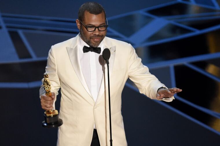 Jordan Peele accepts the award for best original screenplay for “Get Out” at the Oscars on Sunday, March 4, 2018, at the Dolby Theatre in Los Angeles. (Photo by Chris Pizzello/Invision/AP)