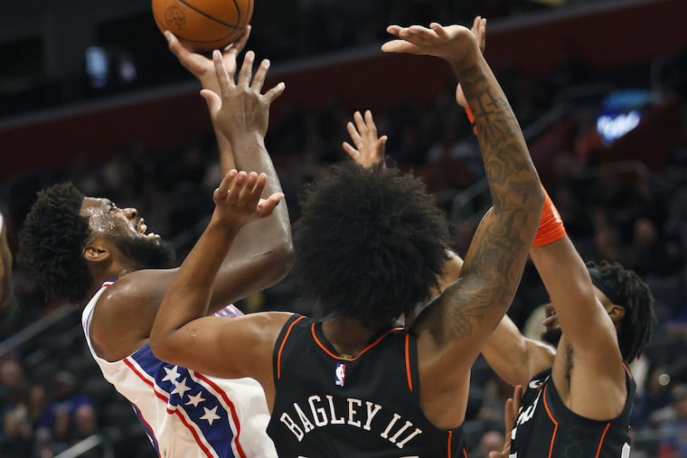 Philadelphia 76ers center Joel Embiid shoots against Detroit Pistons forward Marvin Bagley III (35) and guard Stanley Umude during the first half of an NBA basketball in-season tournament game Friday, Nov. 10, 2023, in Detroit. (AP Photo/Duane Burleson)